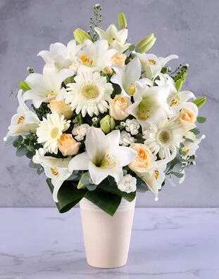 Elegant cream and white flower arrangement in a vase
